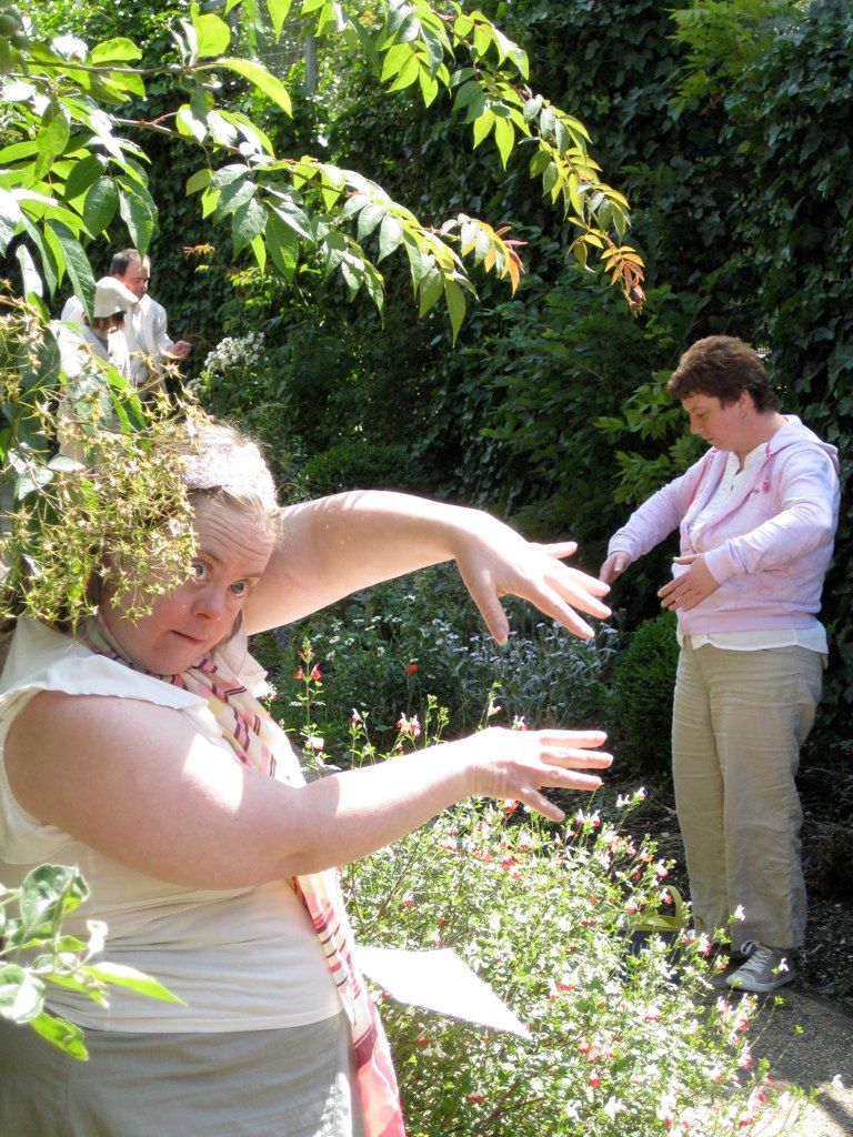 Photo of Jo dancing outside with her hands raised in front of her