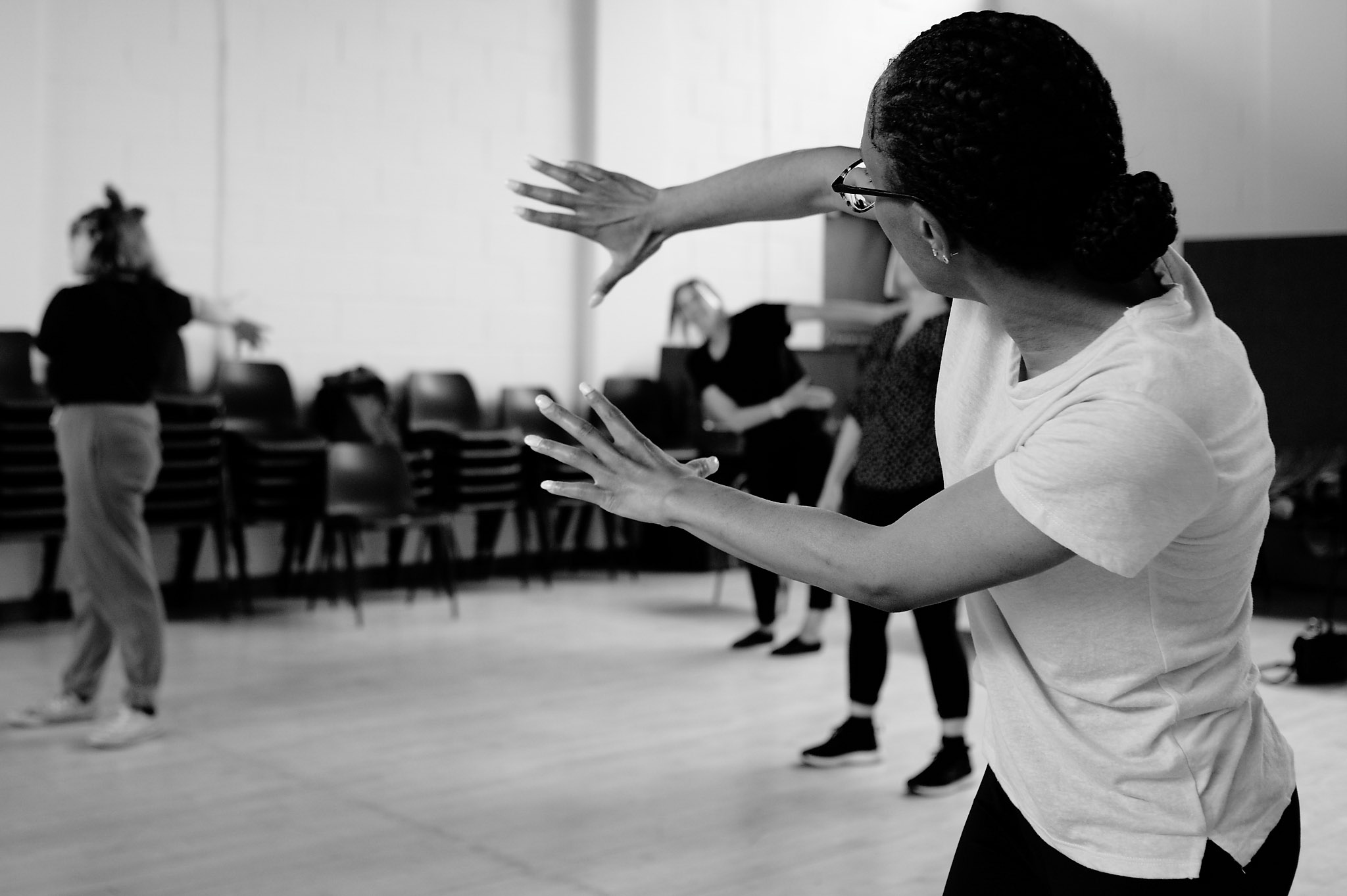 Black and white photo of Nicole dancing at Professional Development Class sharing