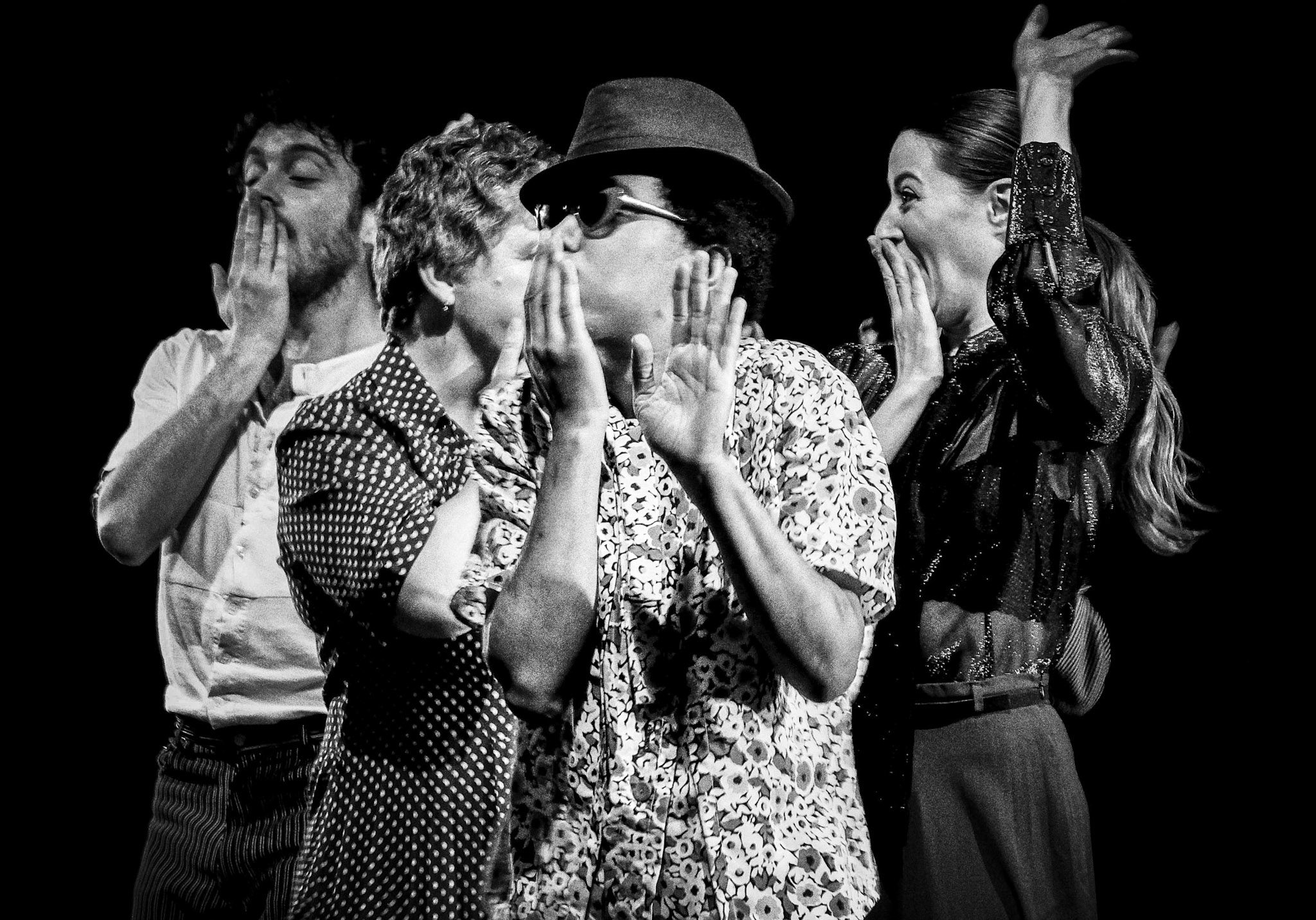 Black & White photo of Veneshia dancing with a hat  and other dancers